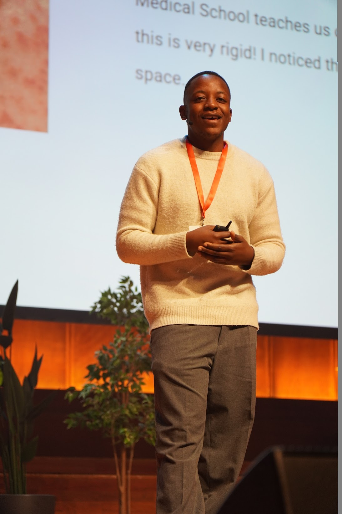 Dr. Malone Mukwende speaking on stage